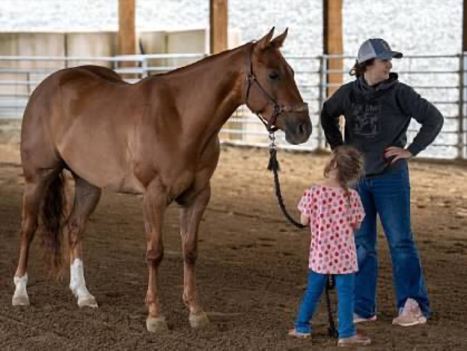 Kimmy and her daughter with their horse in the arena