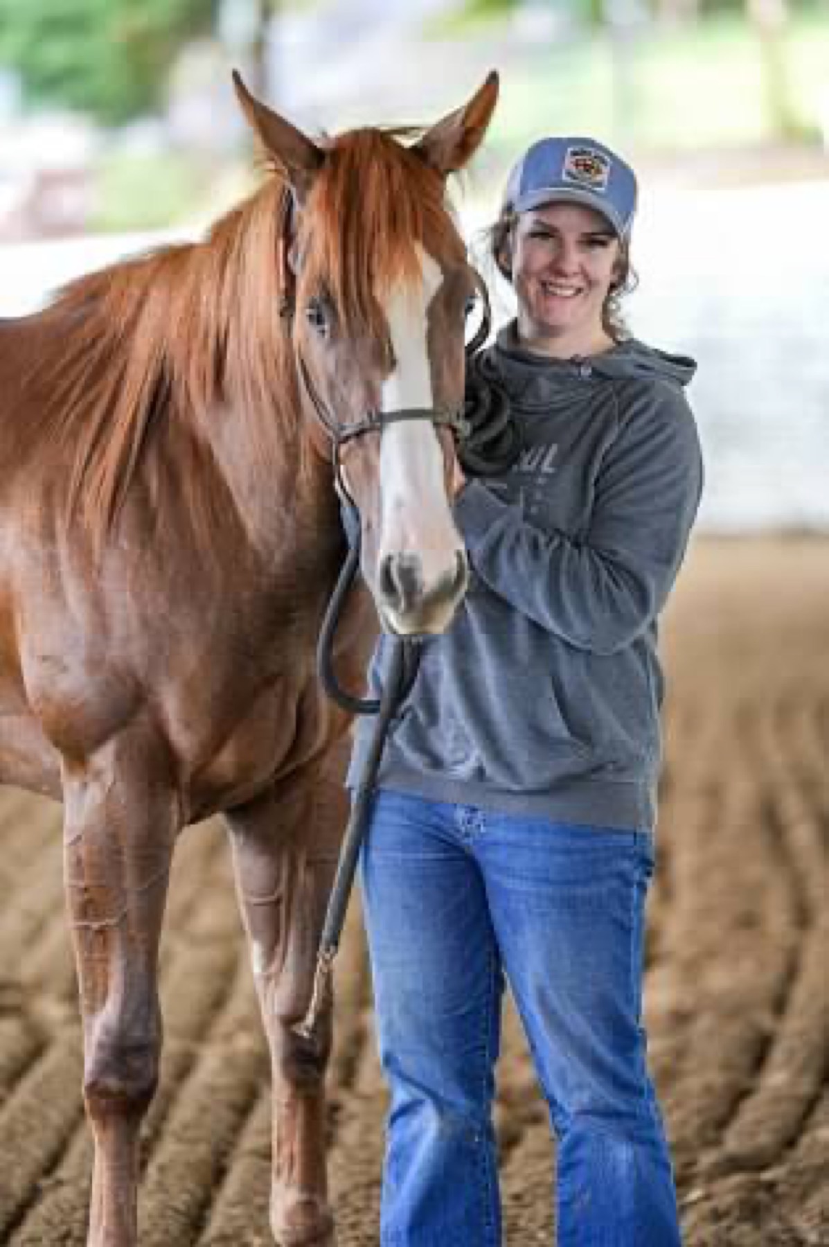 Kimmy Karlovich with her quarter horse at the arena